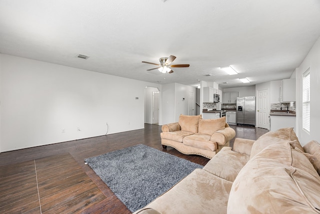 19130 Yaupon Ranch Dr, Cypress, TX 77433 - living area with a ceiling fan and dark wood-style floors