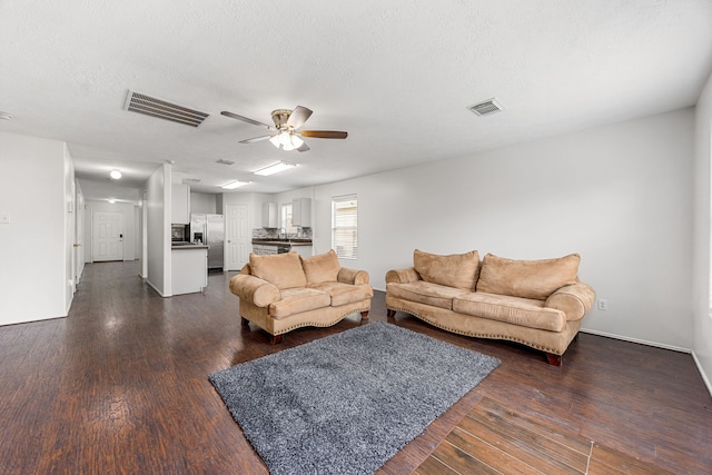 19130 Yaupon Ranch Dr, Cypress, TX 77433 - living area featuring a ceiling fan, dark wood-style floors, baseboards, and a textured ceiling