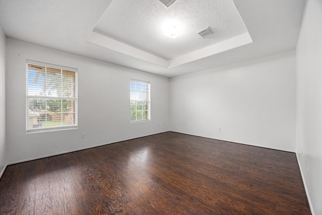 19130 Yaupon Ranch Dr, Cypress, TX 77433 - unfurnished room with a raised ceiling, dark wood-style flooring, a textured ceiling, and baseboards