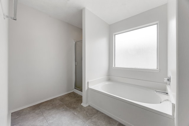 19130 Yaupon Ranch Dr, Cypress, TX 77433 - full bathroom featuring a garden tub, a shower stall, and baseboards