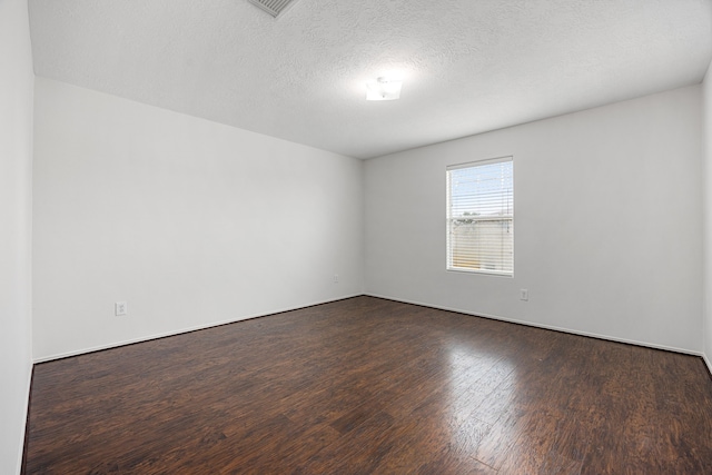 19130 Yaupon Ranch Dr, Cypress, TX 77433 - spare room with dark wood-type flooring and a textured ceiling