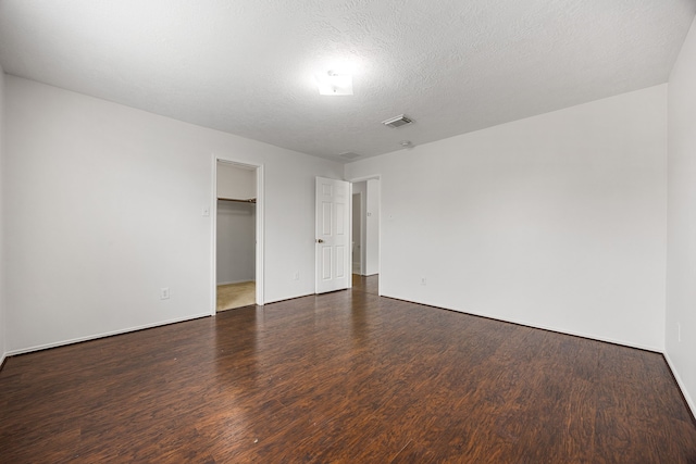19130 Yaupon Ranch Dr, Cypress, TX 77433 - unfurnished bedroom featuring wood finished floors, a spacious closet, baseboards, and a closet
