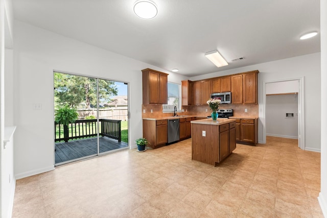 235 Doncaster St, Conroe, TX 77303 - kitchen with stainless steel appliances, a sink, light countertops, and decorative backsplash