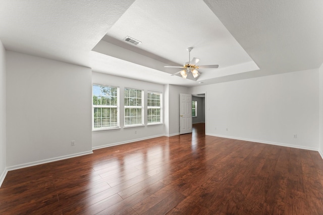 235 Doncaster St, Conroe, TX 77303 - unfurnished living room featuring a raised ceiling, ceiling fan, baseboards, and wood finished floors