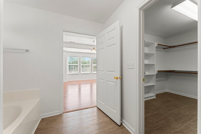 235 Doncaster St, Conroe, TX 77303 - walk in closet featuring wood finished floors and ceiling fan