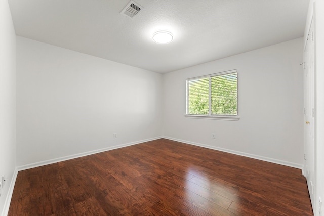 235 Doncaster St, Conroe, TX 77303 - spare room with dark wood finished floors and baseboards