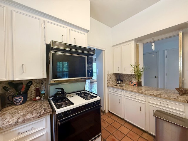 4703 Yoakum Blvd, Houston, TX 77006 - kitchen with range with gas stovetop, black microwave, decorative backsplash, white cabinetry, and light tile patterned floors