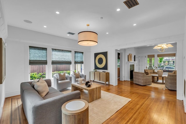 501 Avondale St, Houston, TX 77006 - living room with light wood-style flooring, recessed lighting, a fireplace, and baseboards