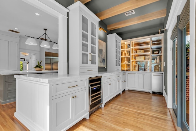 501 Avondale St, Houston, TX 77006 - bar featuring beverage cooler, light wood-type flooring, recessed lighting, and hanging light fixtures
