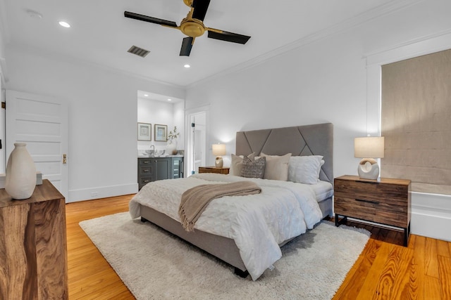 501 Avondale St, Houston, TX 77006 - bedroom with ornamental molding, light wood finished floors, recessed lighting, a ceiling fan, and baseboards