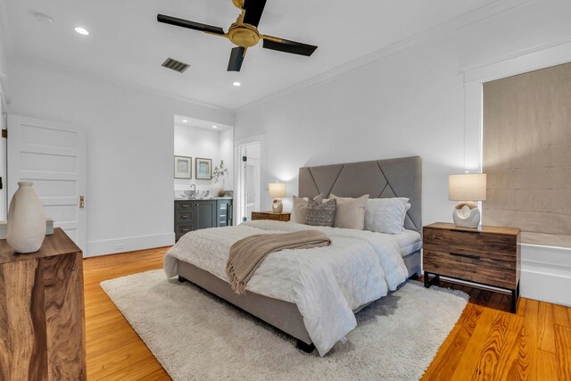 501 Avondale St, Houston, TX 77006 - bedroom with crown molding, light wood-style floors, recessed lighting, ceiling fan, and baseboards