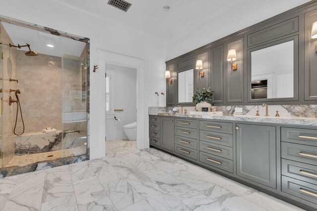 501 Avondale St, Houston, TX 77006 - bathroom with double vanity, a stall shower, toilet, marble look tile flooring, and crown molding