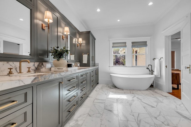 501 Avondale St, Houston, TX 77006 - full bath with double vanity, a freestanding tub, ornamental molding, recessed lighting, and marble finish flooring