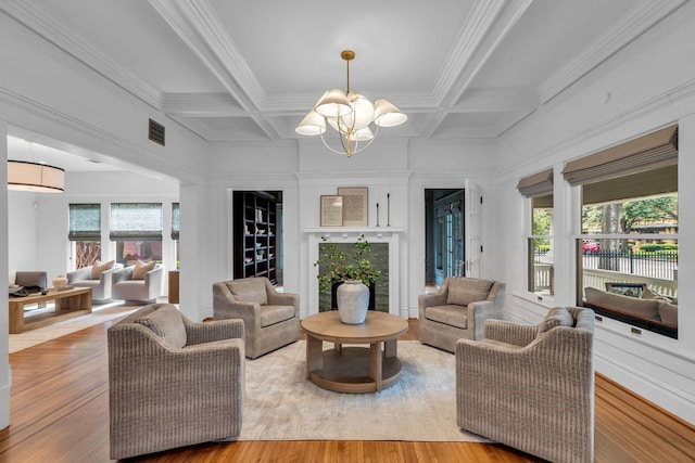 501 Avondale St, Houston, TX 77006 - living room featuring a chandelier, ornamental molding, beamed ceiling, coffered ceiling, and light wood finished floors