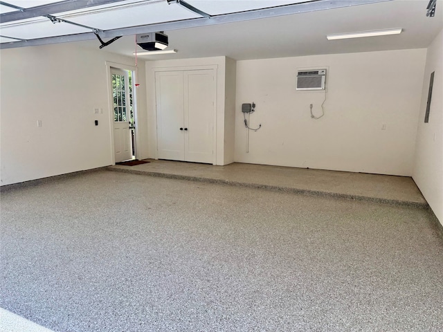 501 Avondale St, Houston, TX 77006 - garage with a wall mounted AC and a garage door opener