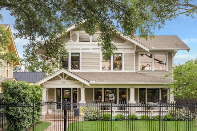 501 Avondale St, Houston, TX 77006 - view of front of property featuring a fenced front yard, a porch, and a shingled roof