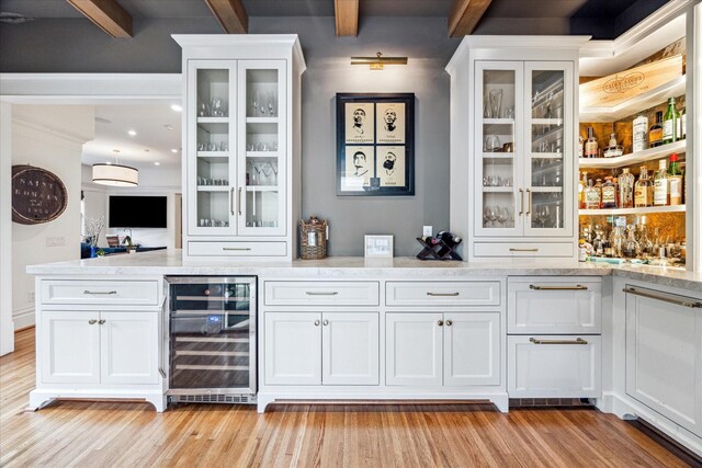 501 Avondale St, Houston, TX 77006 - indoor bar featuring beverage cooler, beam ceiling, and light wood-style flooring