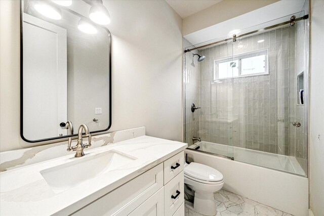 501 Avondale St, Houston, TX 77006 - full bath featuring toilet, vanity, shower / bath combination with glass door, and marble look tile flooring