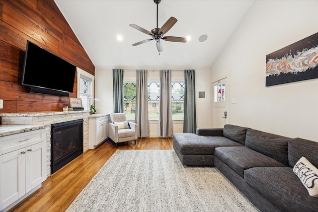 1128 W Temple St, Houston, TX 77009 - living room with a fireplace, light wood finished floors, ceiling fan, and high vaulted ceiling