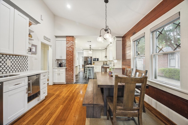 1128 W Temple St, Houston, TX 77009 - dining area featuring plenty of natural light, lofted ceiling, a chandelier, light wood-style flooring, and recessed lighting