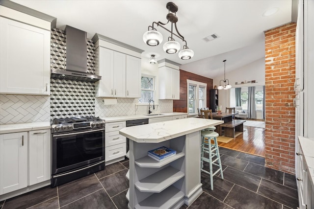 1128 W Temple St, Houston, TX 77009 - kitchen featuring stainless steel range with gas cooktop, wall chimney range hood, a sink, a chandelier, and open shelves