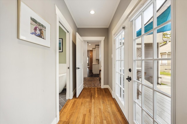 1128 W Temple St, Houston, TX 77009 - corridor with french doors, light wood finished floors, ornamental molding, recessed lighting, and baseboards