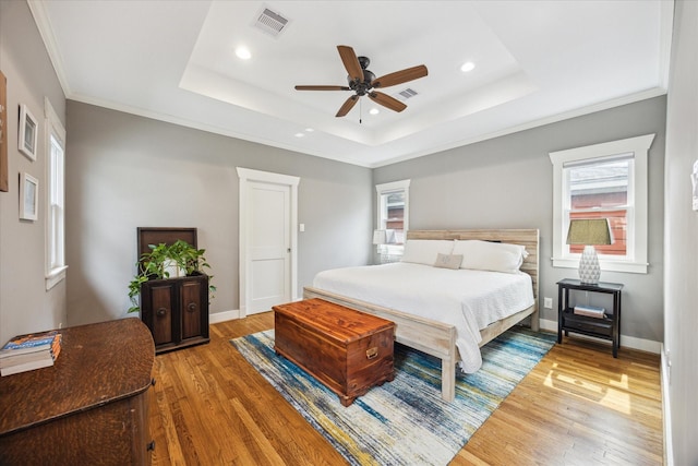 1128 W Temple St, Houston, TX 77009 - bedroom featuring wood finished floors, recessed lighting, a raised ceiling, baseboards, and crown molding