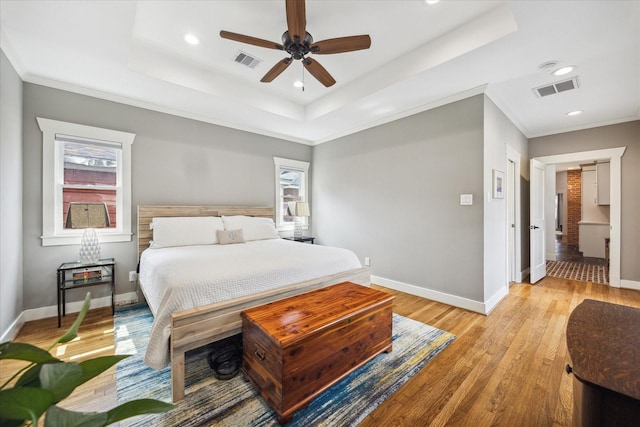 1128 W Temple St, Houston, TX 77009 - bedroom with a raised ceiling, baseboards, light wood-style flooring, recessed lighting, and ornamental molding