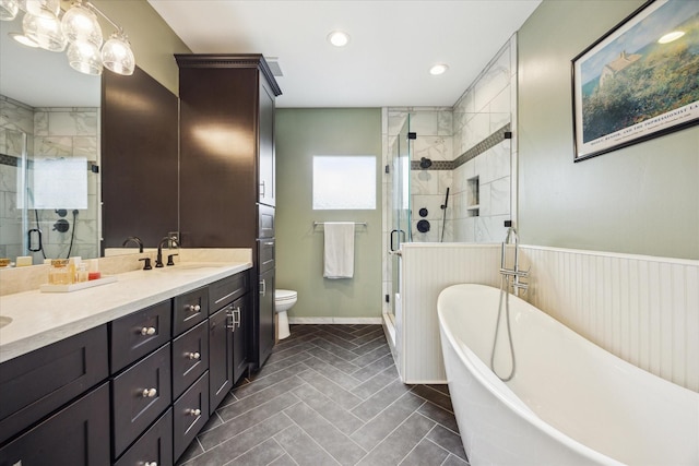1128 W Temple St, Houston, TX 77009 - bathroom with toilet, a freestanding tub, a stall shower, double vanity, and recessed lighting