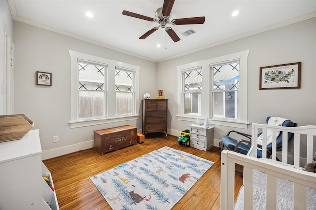 1128 W Temple St, Houston, TX 77009 - bedroom featuring ornamental molding, baseboards, wood finished floors, recessed lighting, and a ceiling fan