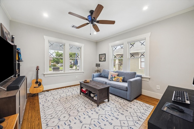 1128 W Temple St, Houston, TX 77009 - living room featuring light wood-type flooring, ceiling fan, baseboards, ornamental molding, and recessed lighting