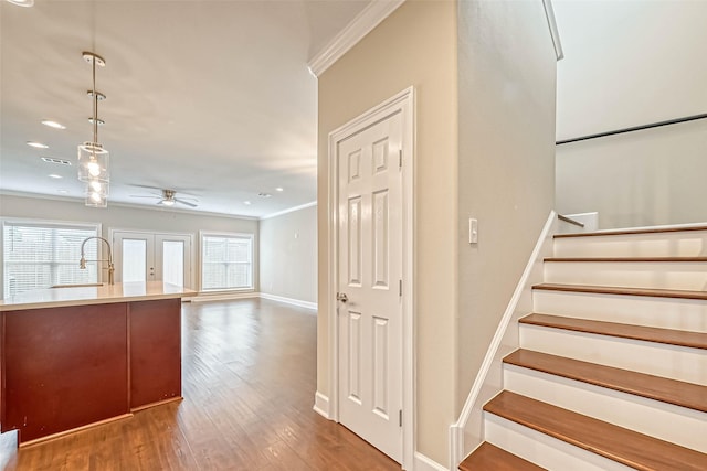 503 E 40th 1/2 St Unit A, Houston, TX 77022 - staircase with crown molding, baseboards, wood finished floors, ceiling fan, and recessed lighting