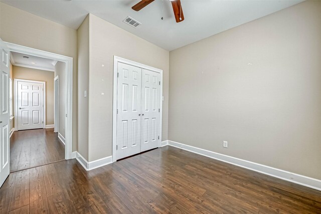 503 E 40th 1/2 St Unit A, Houston, TX 77022 - unfurnished bedroom featuring dark wood-type flooring, baseboards, a closet, and ceiling fan