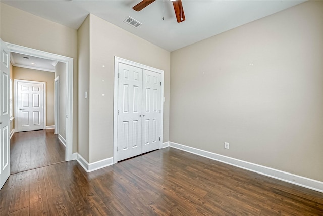 503 E 40th 1/2 St Unit A, Houston, TX 77022 - unfurnished bedroom featuring dark wood-type flooring, baseboards, a closet, and ceiling fan