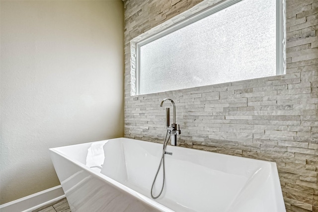 503 E 40th 1/2 St Unit A, Houston, TX 77022 - bathroom with a freestanding tub, plenty of natural light, and baseboards