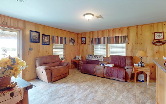1321 Pickney Ave, Port Bolivar, TX 77650 - living room featuring healthy amount of natural light and wood walls