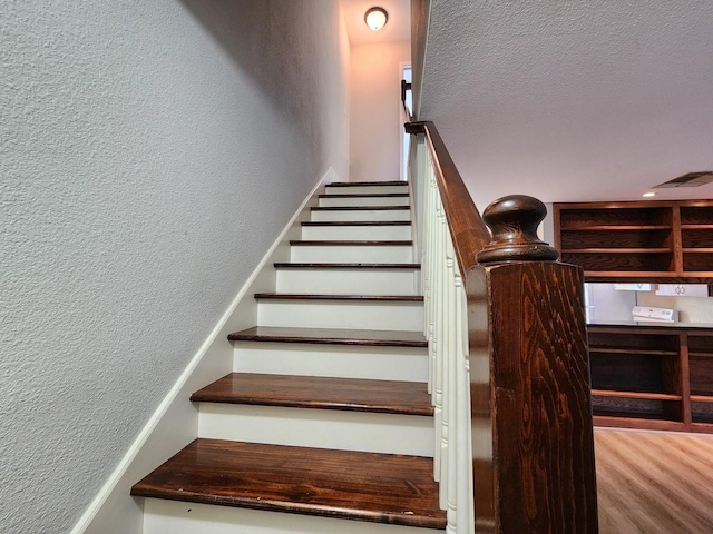 1205 Autrey St Unit 11, Houston, TX 77006 - stairs featuring a textured wall and wood finished floors