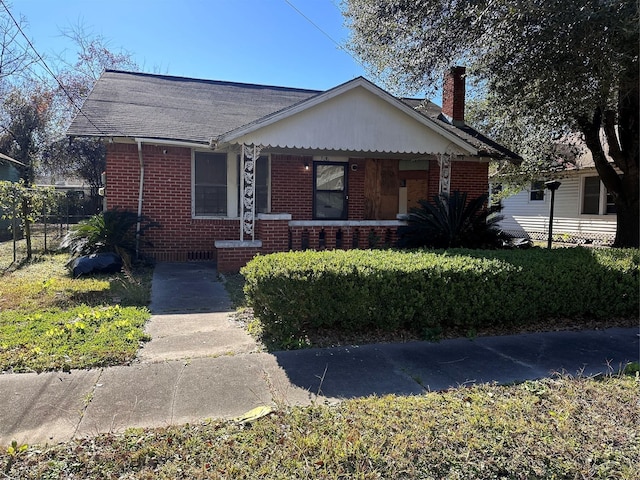 3016 Gray St, Houston, TX 77004 - bungalow featuring brick siding, a chimney, a porch, and roof with shingles