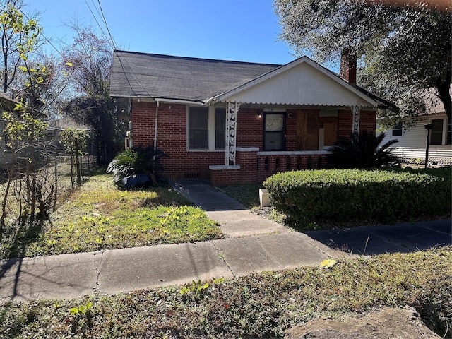 3016 Gray St, Houston, TX 77004 - bungalow-style home with brick siding, a porch, a chimney, and roof with shingles