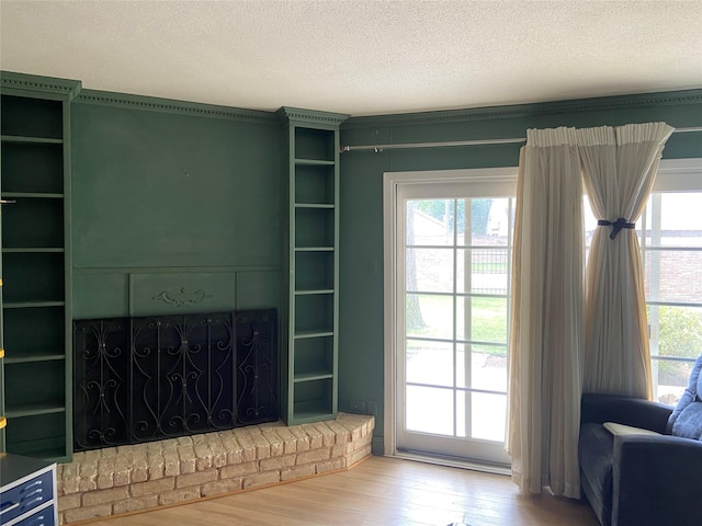 14515 N Wunderlich Dr Unit 315, Houston, TX 77069 - unfurnished living room with wood finished floors, healthy amount of natural light, a textured ceiling, and a fireplace