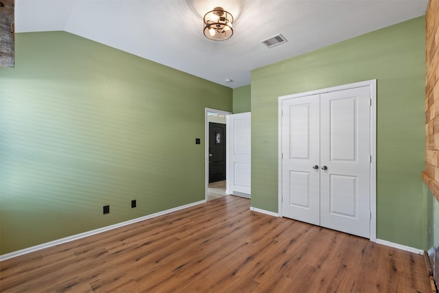 323 Jewett Meadow Dr, Magnolia, TX 77354 - unfurnished bedroom featuring wood finished floors, a closet, and baseboards