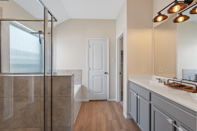 323 Jewett Meadow Dr, Magnolia, TX 77354 - full bath with wood finished floors, double vanity, a bath, a stall shower, and lofted ceiling