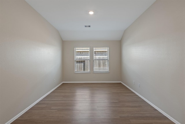 323 Jewett Meadow Dr, Magnolia, TX 77354 - spare room featuring dark wood-style flooring, lofted ceiling, and baseboards