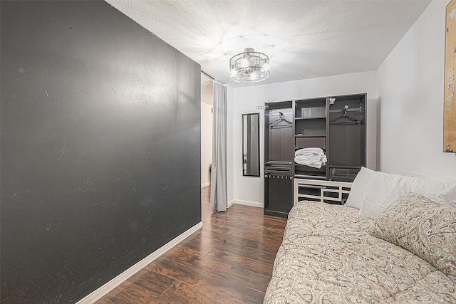3131 Cummins St Unit 11, Houston, TX 77027 - bedroom featuring a chandelier, wood finished floors, and baseboards