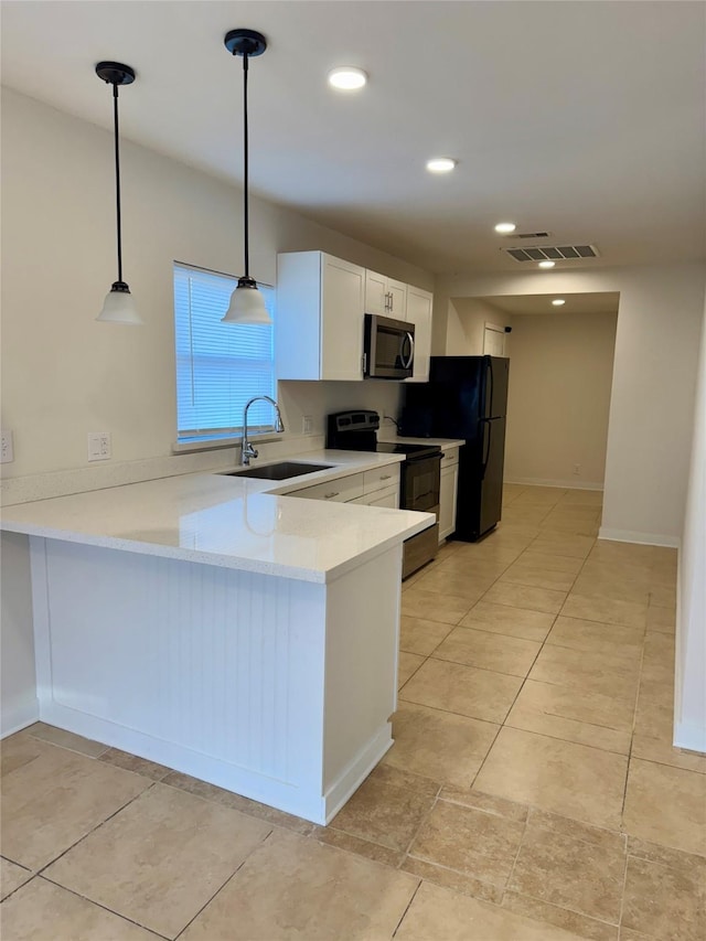 7318 Thurow St, Houston, TX 77087 - kitchen featuring electric range, a sink, stainless steel microwave, white cabinets, and light countertops