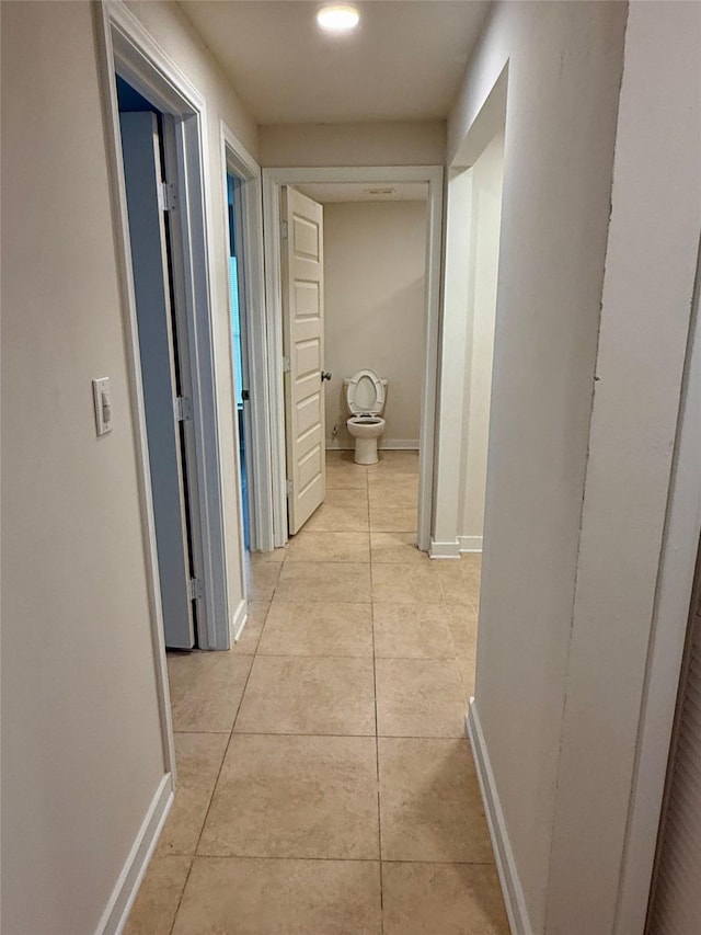 7318 Thurow St, Houston, TX 77087 - hall featuring light tile patterned floors and baseboards
