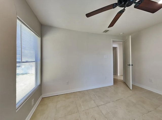 7318 Thurow St, Houston, TX 77087 - unfurnished room with a ceiling fan, plenty of natural light, light tile patterned floors, and baseboards