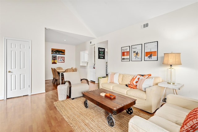 5200 Weslayan St Unit 309, Houston, TX 77005 - living area featuring light wood finished floors and high vaulted ceiling