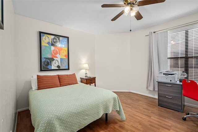 5200 Weslayan St Unit 309, Houston, TX 77005 - bedroom featuring baseboards, wood finished floors, and ceiling fan
