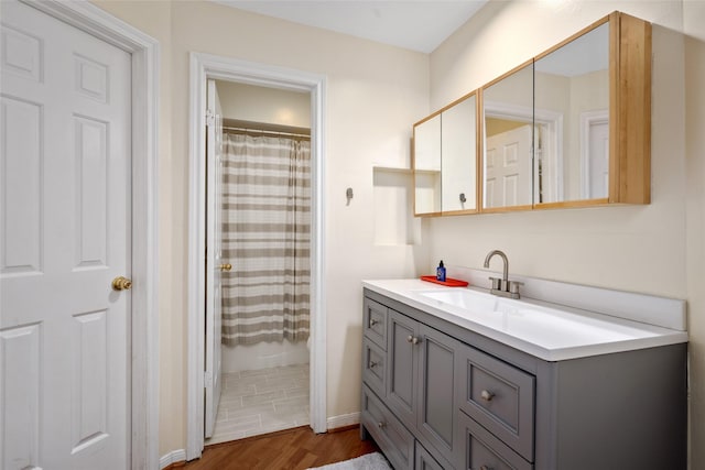 5200 Weslayan St Unit 309, Houston, TX 77005 - full bathroom featuring vanity, wood finished floors, and a shower with curtain
